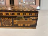a small wooden box with a decorative design on it