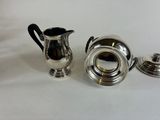 two silverplated coffee pots and a silverplated sugar shaker