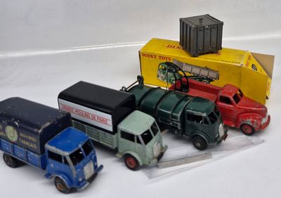 several toy trucks are lined up next to each other on a white surface