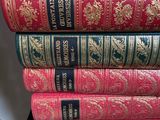 several books stacked on top of each other on a shelf