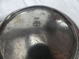 a silver pot with a lid on a white table