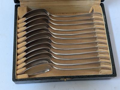 several spoons are in a box with a lid on a table