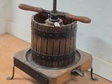 a small wooden machine that is on a tile floor
