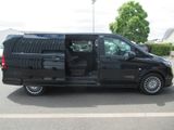a black van parked in a parking lot with its doors open