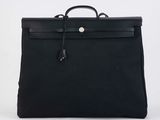 a black leather briefcase with a handle on a white background