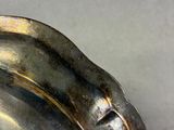 a close up of a silver plate on a table