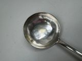 a silver spoon with a spoon handle on a table
