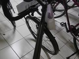 many bikes that are parked in a room together