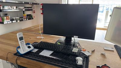 a computer desk with a keyboard and a monitor on it