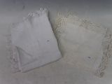 two white handkerchiefs on a white table cloth