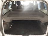 the back of a car with the trunk open and the seats folded down
