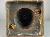 a close up of a metal object with a hole in it