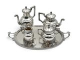 two silver teapots on a silver tray on a white background
