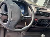 dashboard view of a vehicle with a steering wheel and dashboard controls