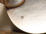a close up of a metal object with a knife in it