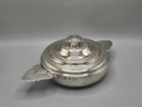 an antique silver plated teapot with a lid on a table