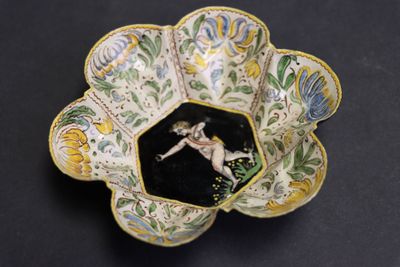 a small bowl with a picture of a woman on it