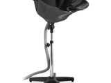 a close up of a black hair dryer on a stand