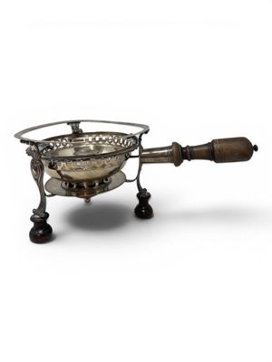 a silver plated cheese grater with a wooden handle