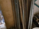 a white bucket sitting next to a stack of wooden planks