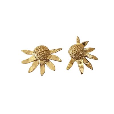 a pair of gold tone earrings with a flower design