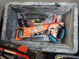 many tools in a box that are sitting on the floor