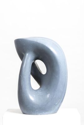 a blue sculpture sitting on top of a white pedestal