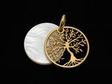 a gold plated tree of life pendant on a black background