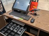 a laptop computer sitting on a desk in a store