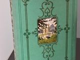a green book with a picture of a castle on it