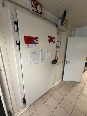 a white refrigerator and a white refrigerator freezer in a room