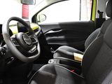 the interior of a small car with black seats and a yellow steering wheel