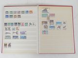 an open book with stamps on it sitting on a table