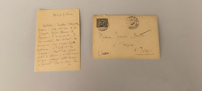an old postcard with a handwritten letter on it next to a piece of paper with a stamp on it