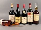 several bottles of wine sitting next to each other on a table