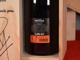 a bottle of red wine in a wooden box