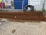 a pile of wire mesh on the ground next to a building