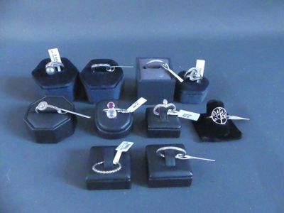 many different types of jewelry on display on a table