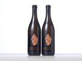 two bottles of wine sitting on top of a table