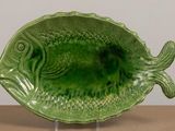 a green fish shaped dish on a table