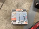 a box of power cord on the floor next to a pair of scissors