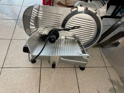 a large slicer that is sitting on the floor