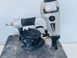 a stapler that is sitting on top of a piece of concrete