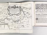 an open book with a map of france on it sitting on top of a table