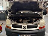 a white van with its hood open in a garage