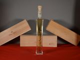 a bottle of liquor sitting on a table next to wooden boxes