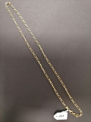 a gold chain necklace with a tag on it
