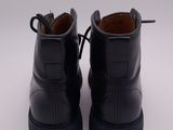 black leather boots with black soles on a white surface