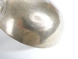 a silver object that is sitting on a white surface