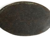 an old metal plate that has a hole in it